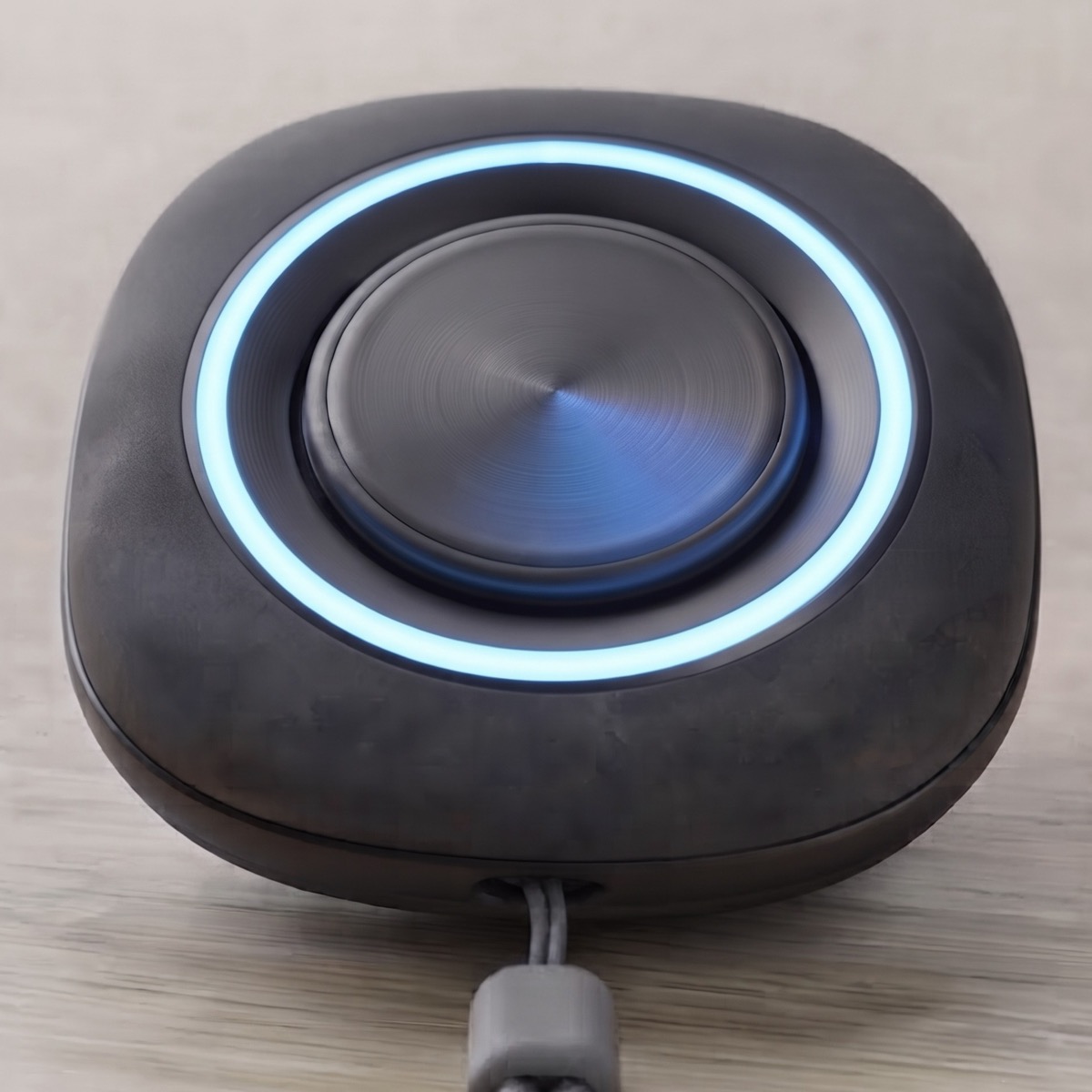 The pendant seen from above, the ring around its button lit.